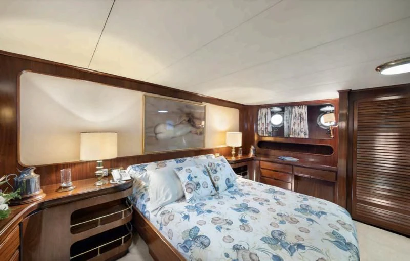 a bedroom with a bed and a desk aboard ATHINA Yacht for Sale