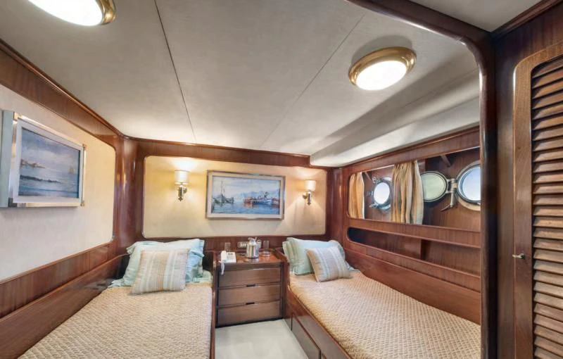 a bedroom with a bed and a mirror aboard ATHINA Yacht for Sale