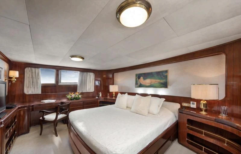 a hotel room with a bed and desk aboard ATHINA Yacht for Sale