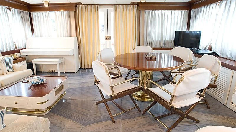 a living room with a table and chairs aboard ATHINA Yacht for Sale