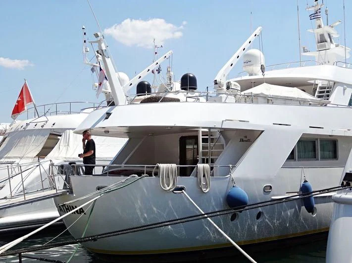 a couple of people standing on a boat aboard ATHINA Yacht for Sale