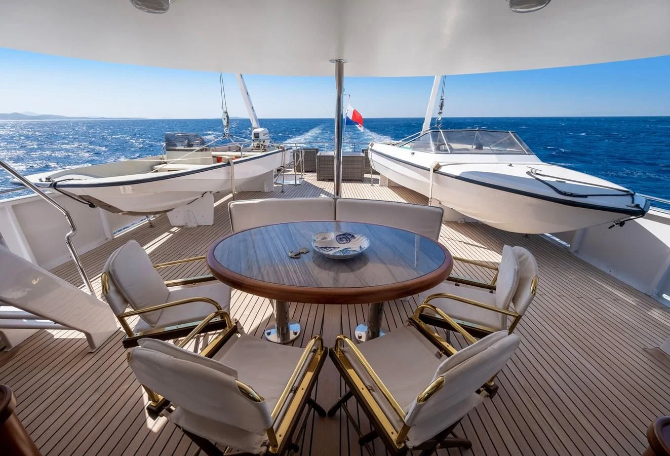 a table and chairs on a boat aboard ATHINA Yacht for Sale