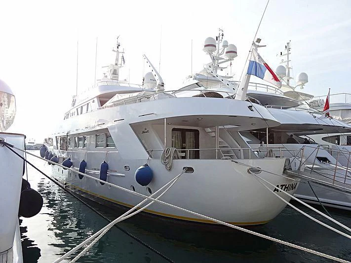 a white boat with flags on it aboard ATHINA Yacht for Sale