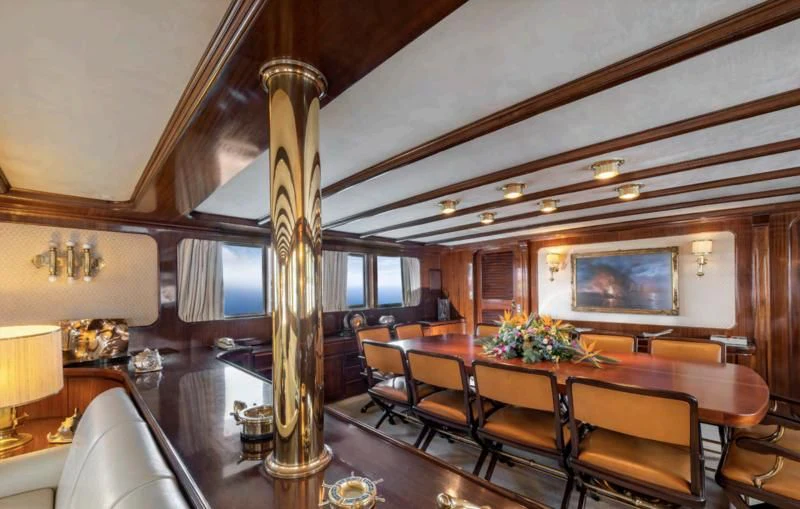 a large room with a table and chairs aboard ATHINA Yacht for Sale
