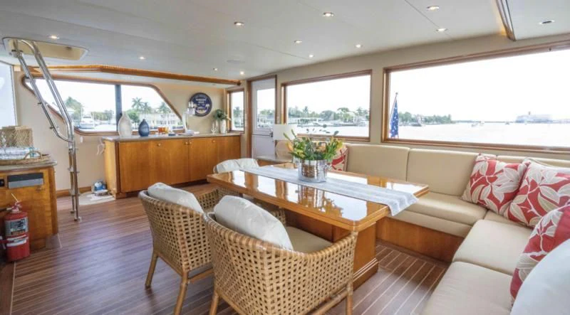 a living room with a table and chairs aboard WELL DONE Yacht for Sale