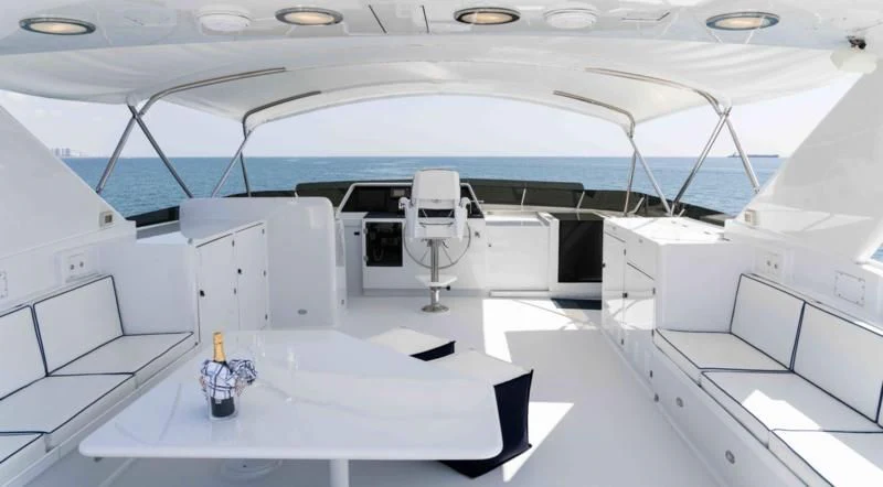 a large white room with a large white table and chairs aboard WELL DONE Yacht for Sale