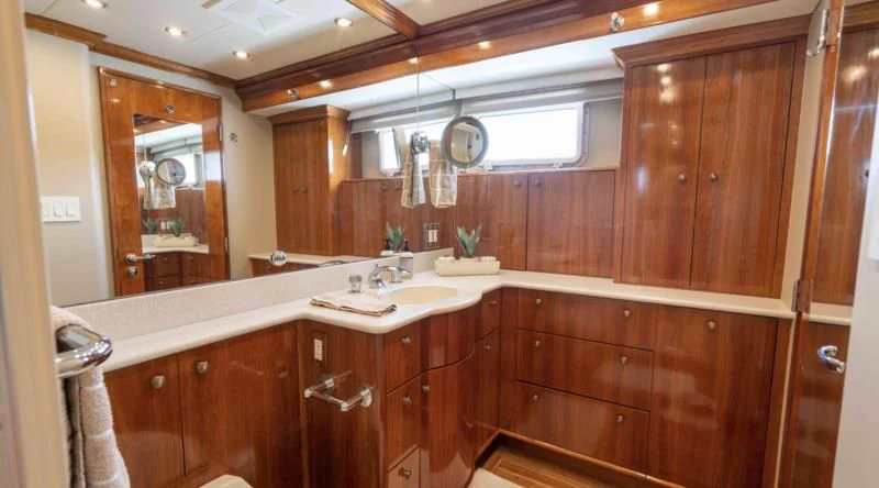 a bathroom with wooden cabinets aboard WELL DONE Yacht for Sale