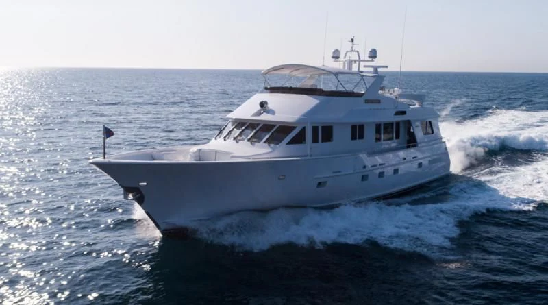 a large white boat in the water aboard WELL DONE Yacht for Sale