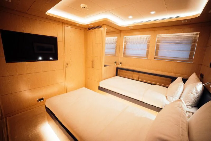 a room with a bed and a tv aboard HEEUS Yacht for Sale