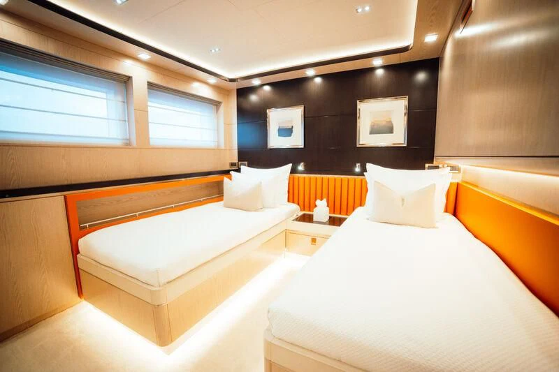 a room with beds and a tv aboard HEEUS Yacht for Sale