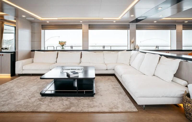 a living room with a couch and a coffee table aboard HEEUS Yacht for Sale
