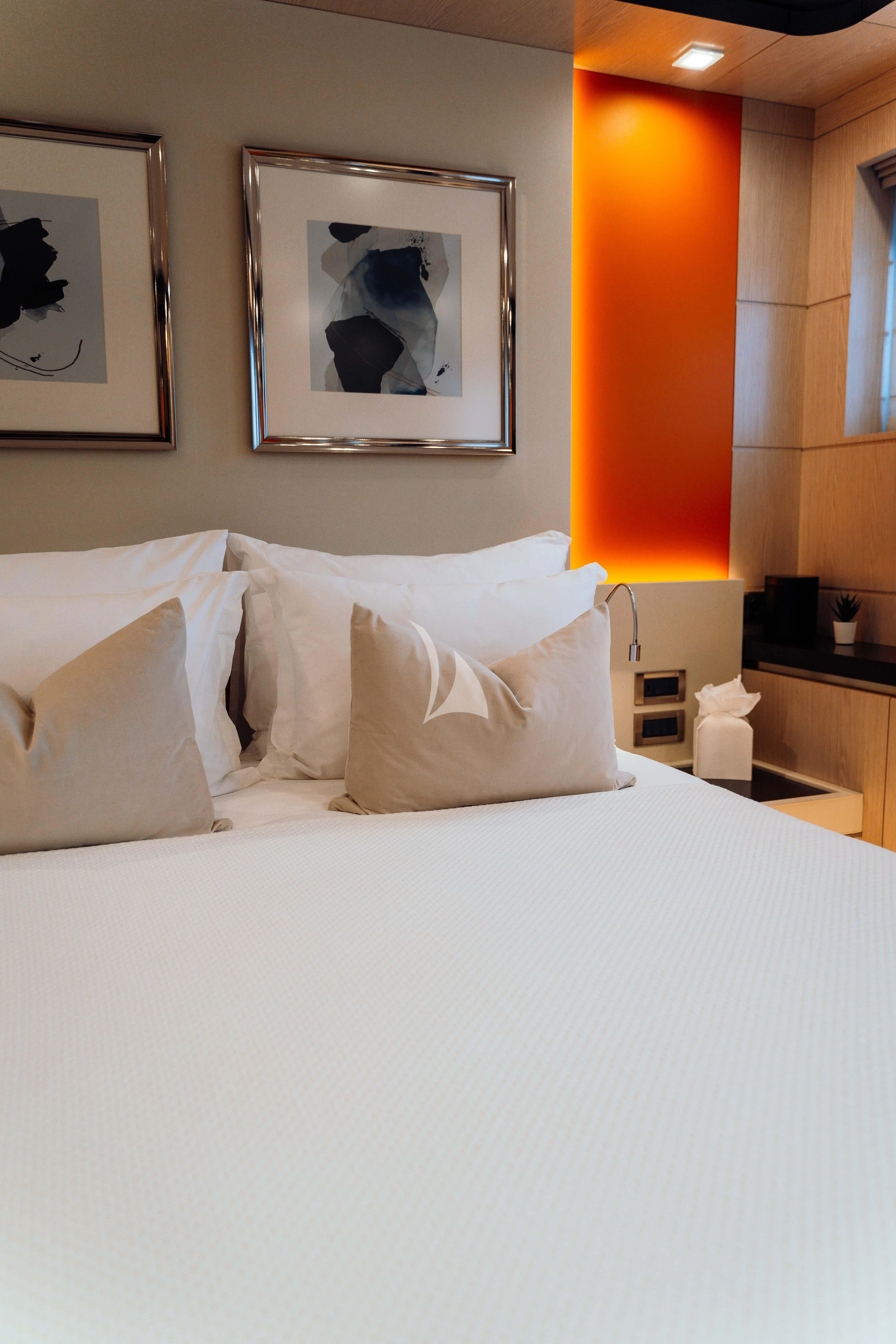 a bed with white sheets and pillows aboard HEEUS Yacht for Sale