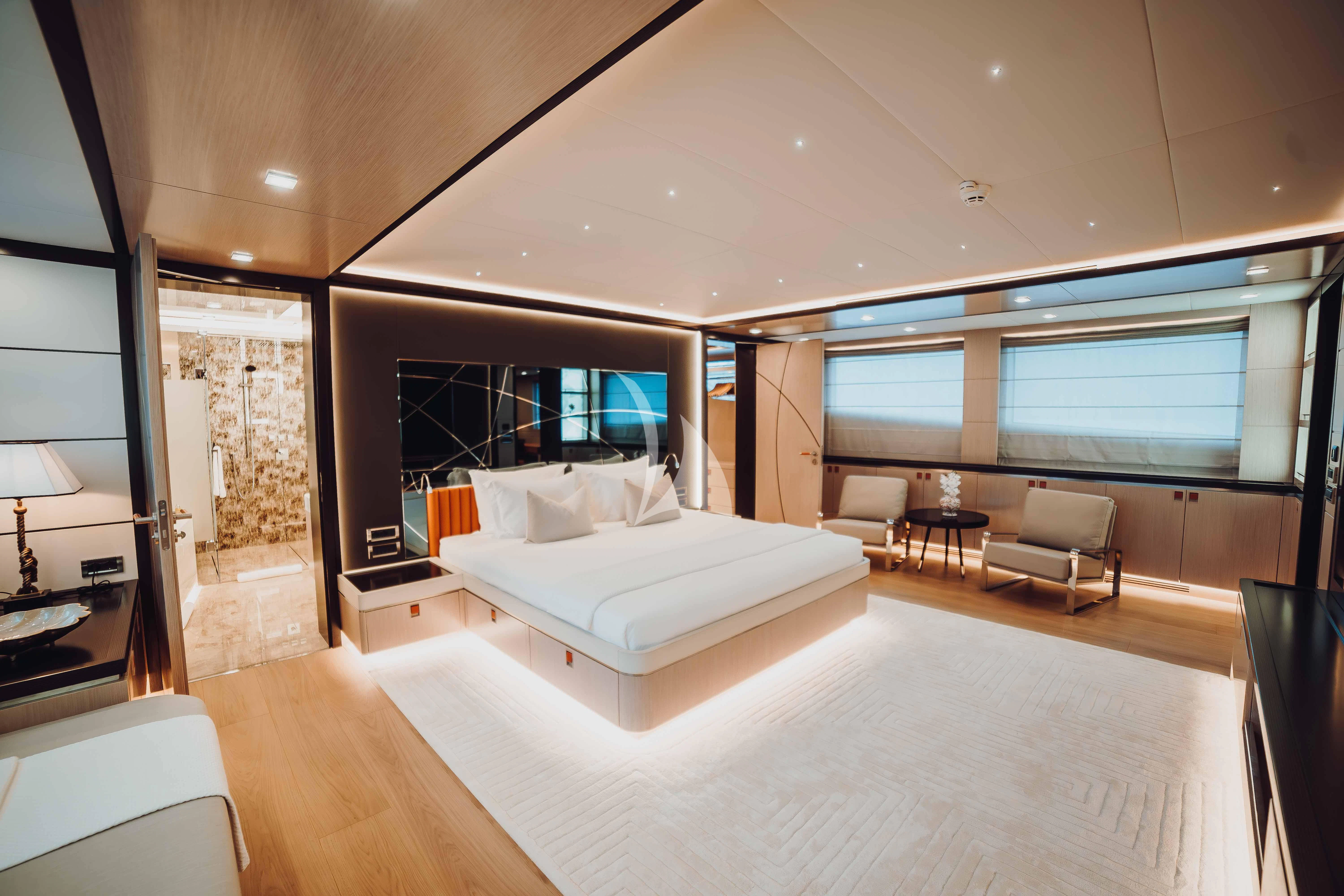 a large modern bedroom aboard HEEUS Yacht for Sale