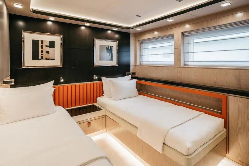 a room with a couple of beds aboard HEEUS Yacht for Sale