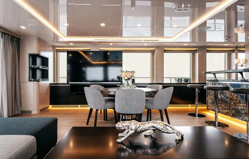 a room with a table and chairs aboard HEEUS Yacht for Sale