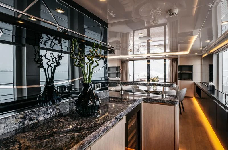 a large kitchen with marble counters aboard HEEUS Yacht for Sale
