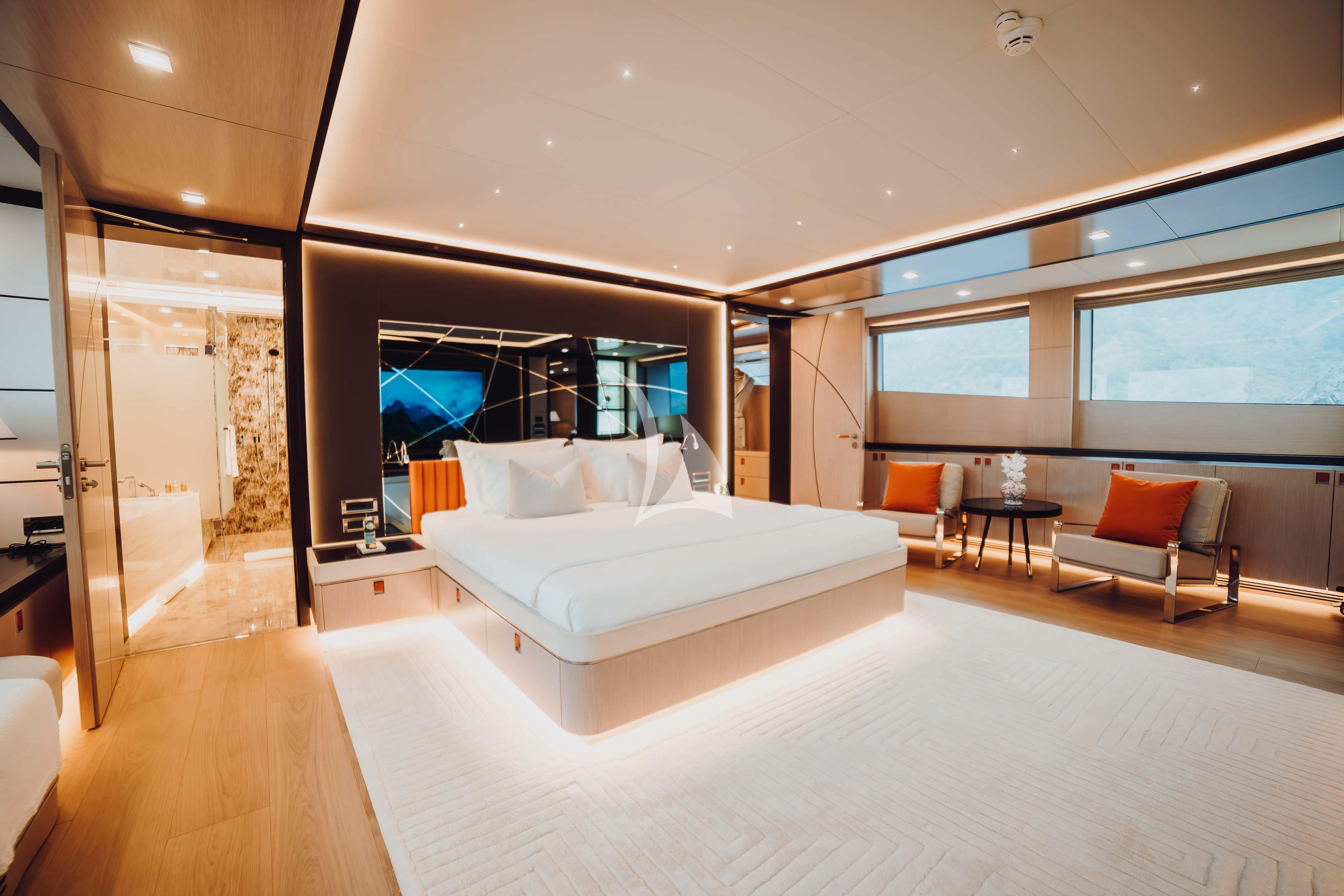 a room with a bed and a chair aboard HEEUS Yacht for Sale