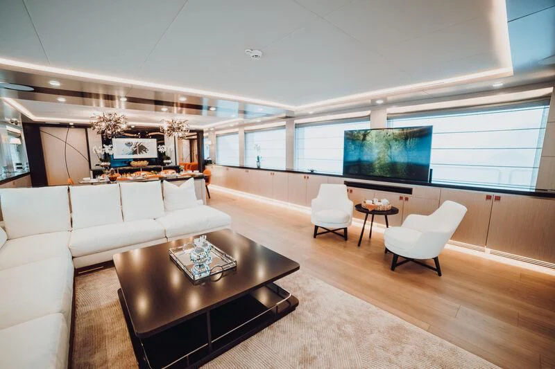 a living room with a large screen aboard HEEUS Yacht for Sale