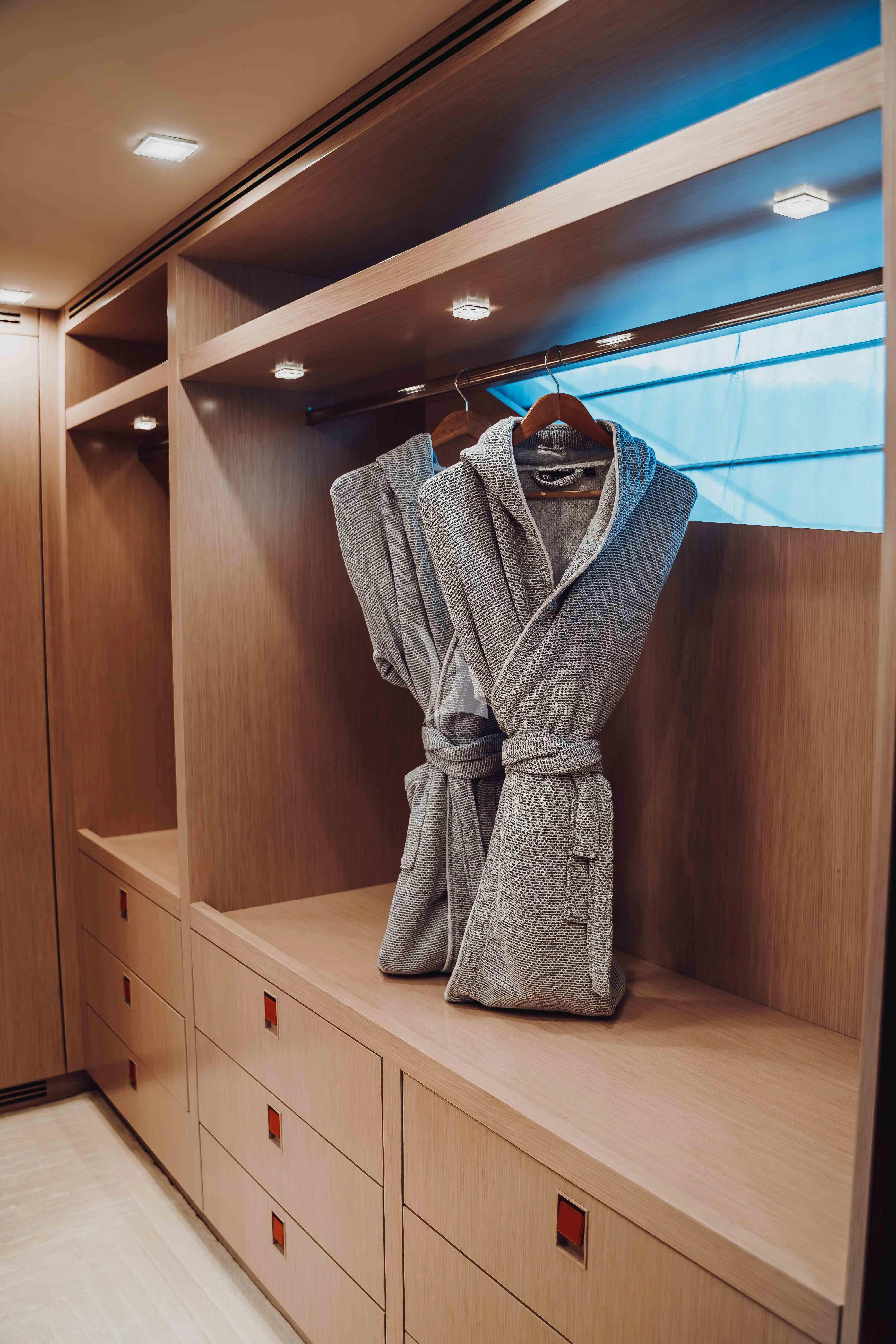 a mannequin wearing a white suit and white shirt aboard HEEUS Yacht for Sale