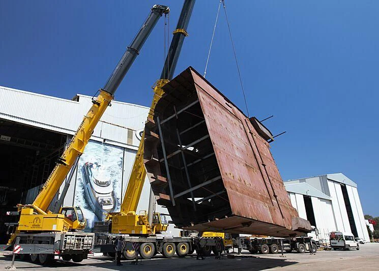 a large crane with a large piece of metal aboard HEEUS Yacht for Sale