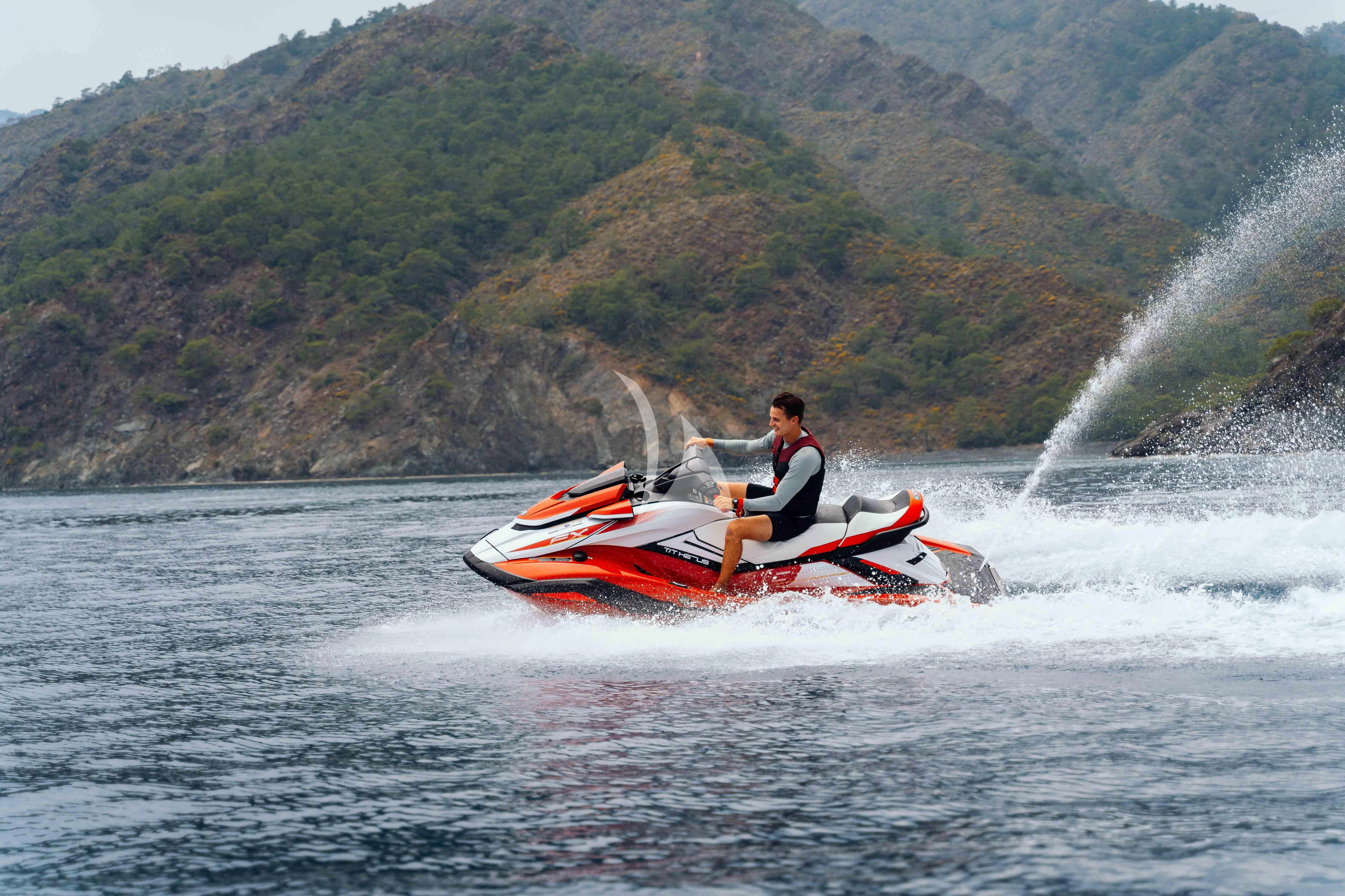a man on a jet ski aboard HEEUS Yacht for Sale