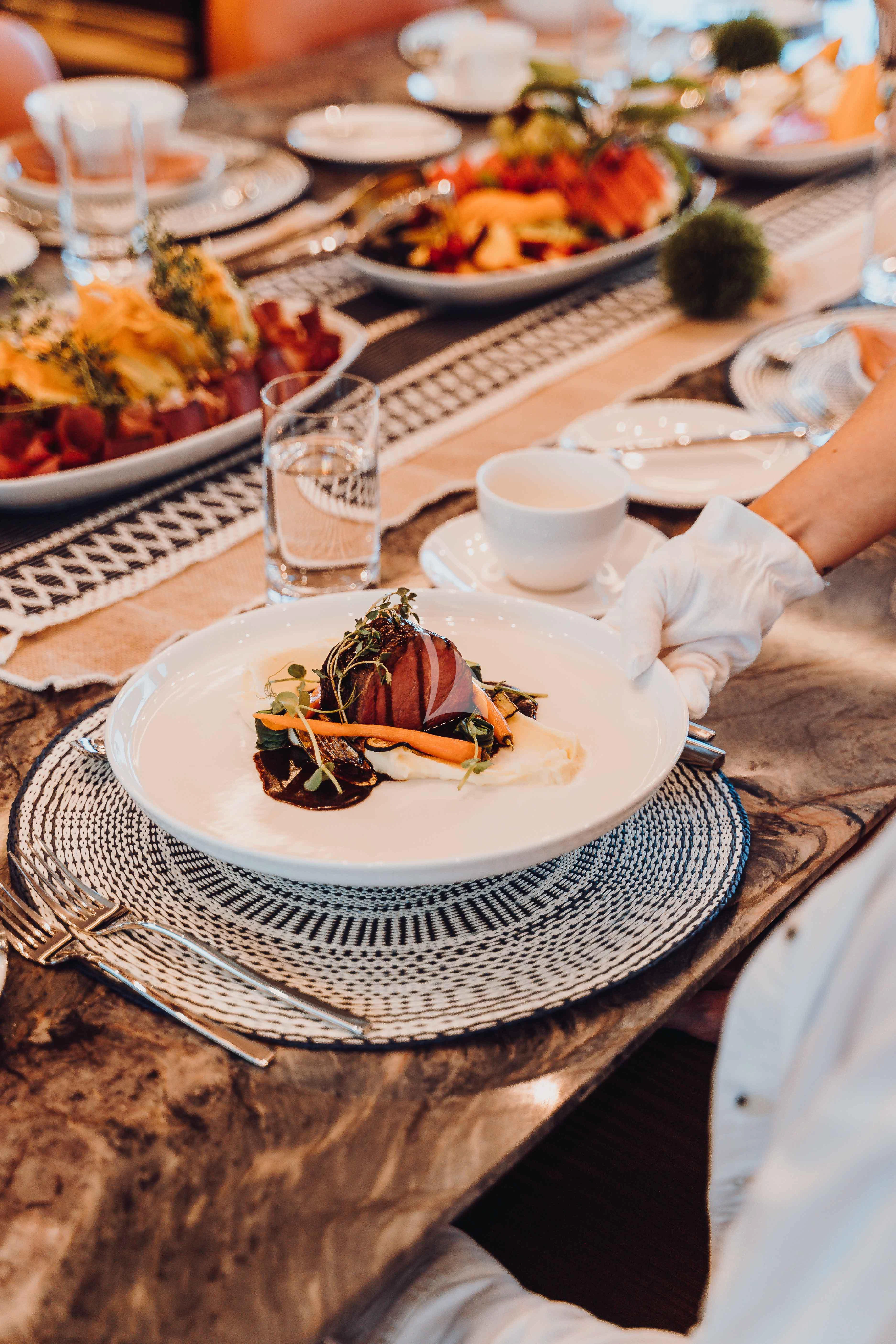 a table with plates of food aboard HEEUS Yacht for Sale
