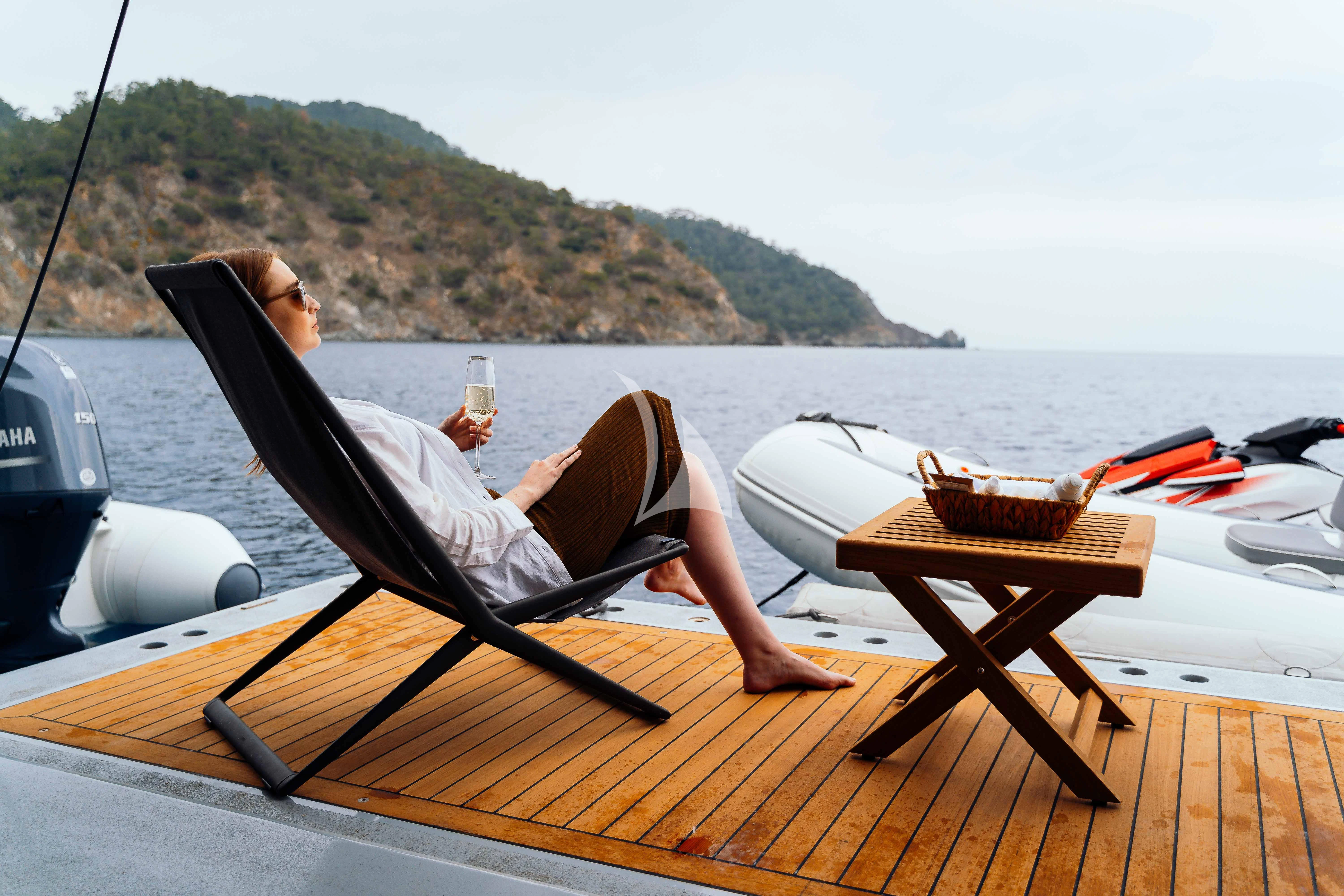 a person lying on a boat aboard HEEUS Yacht for Sale