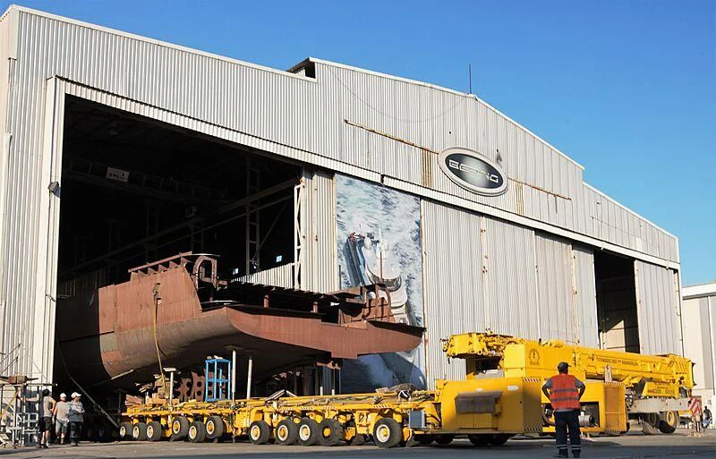 a large machine with a person standing next to it aboard HEEUS Yacht for Sale