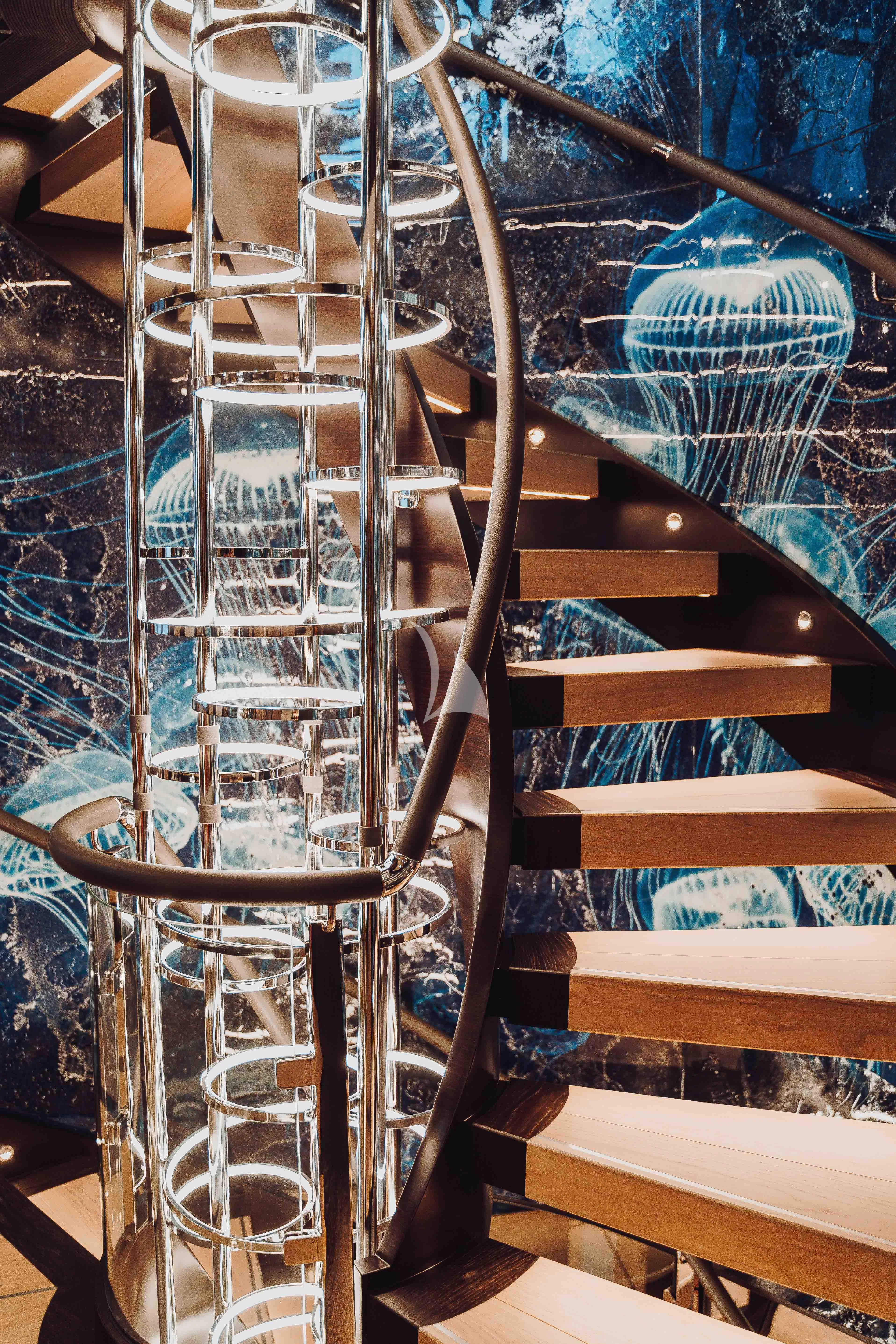 a chair with a chair and a table in the background aboard HEEUS Yacht for Sale