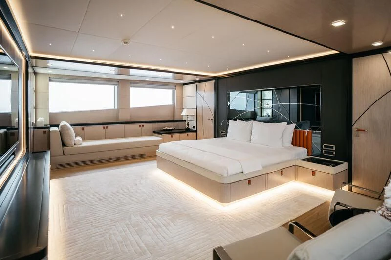 a room with a bed and a couch aboard HEEUS Yacht for Sale