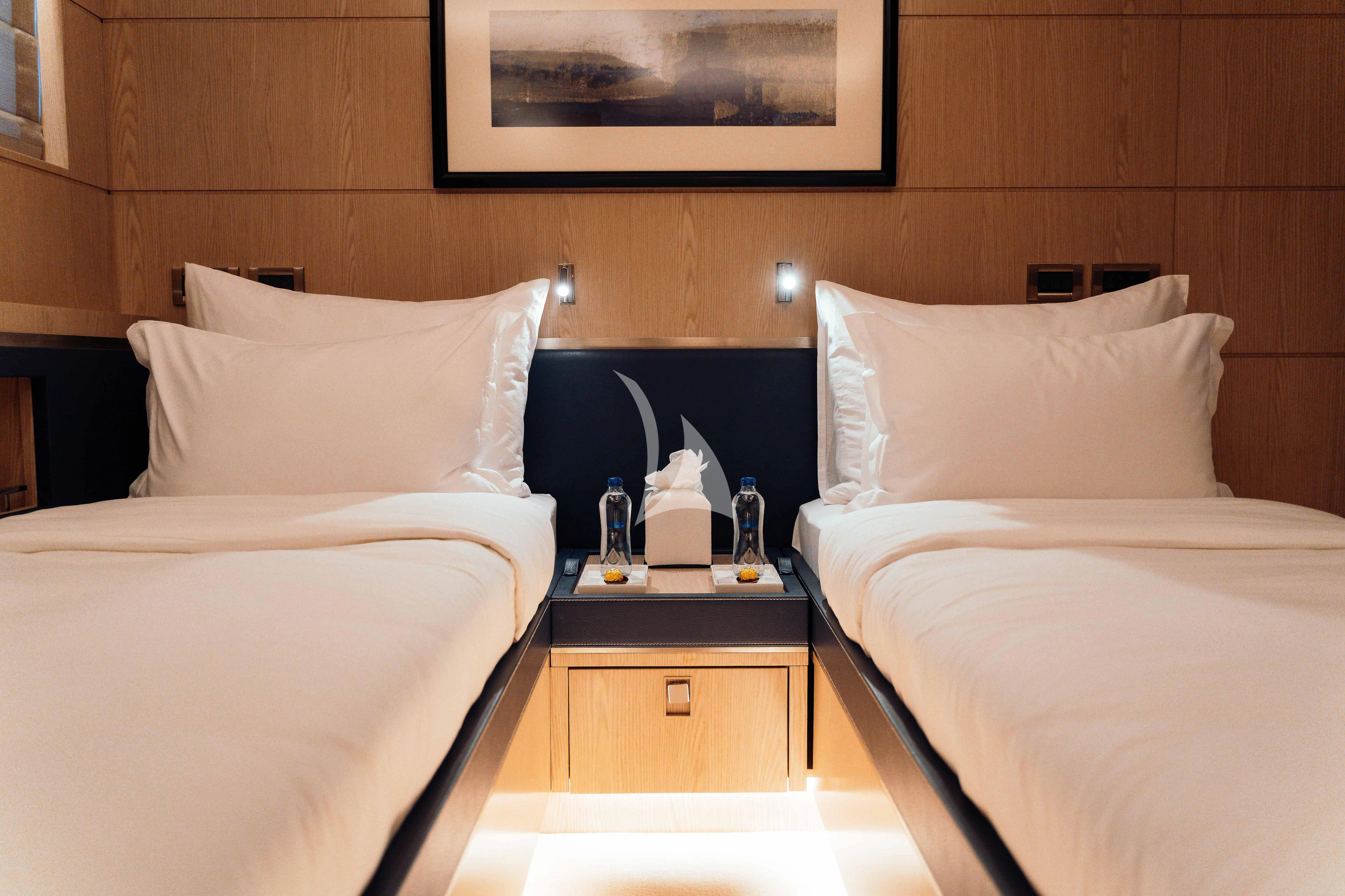a room with two beds aboard HEEUS Yacht for Sale