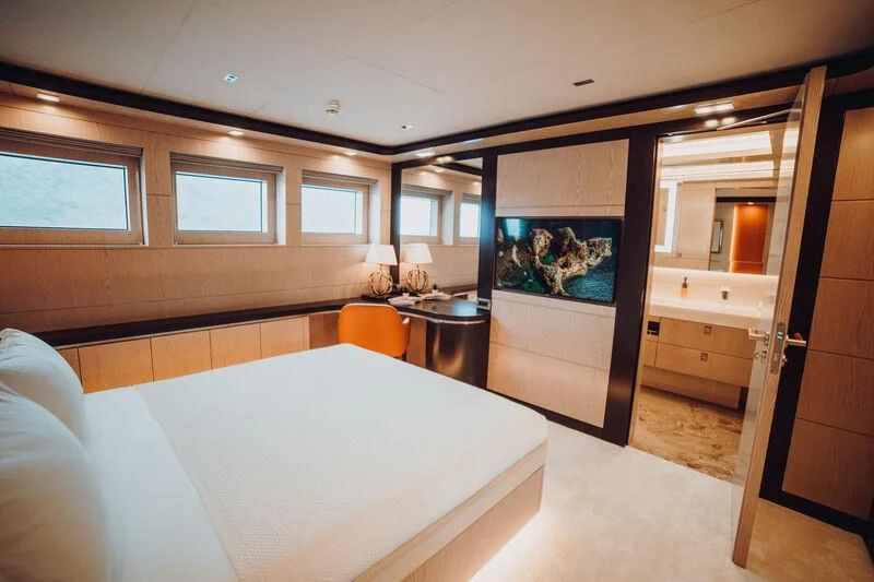 a room with a table and a bed aboard HEEUS Yacht for Sale