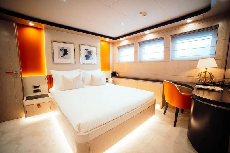 a hotel room with a bed and desk aboard HEEUS Yacht for Sale