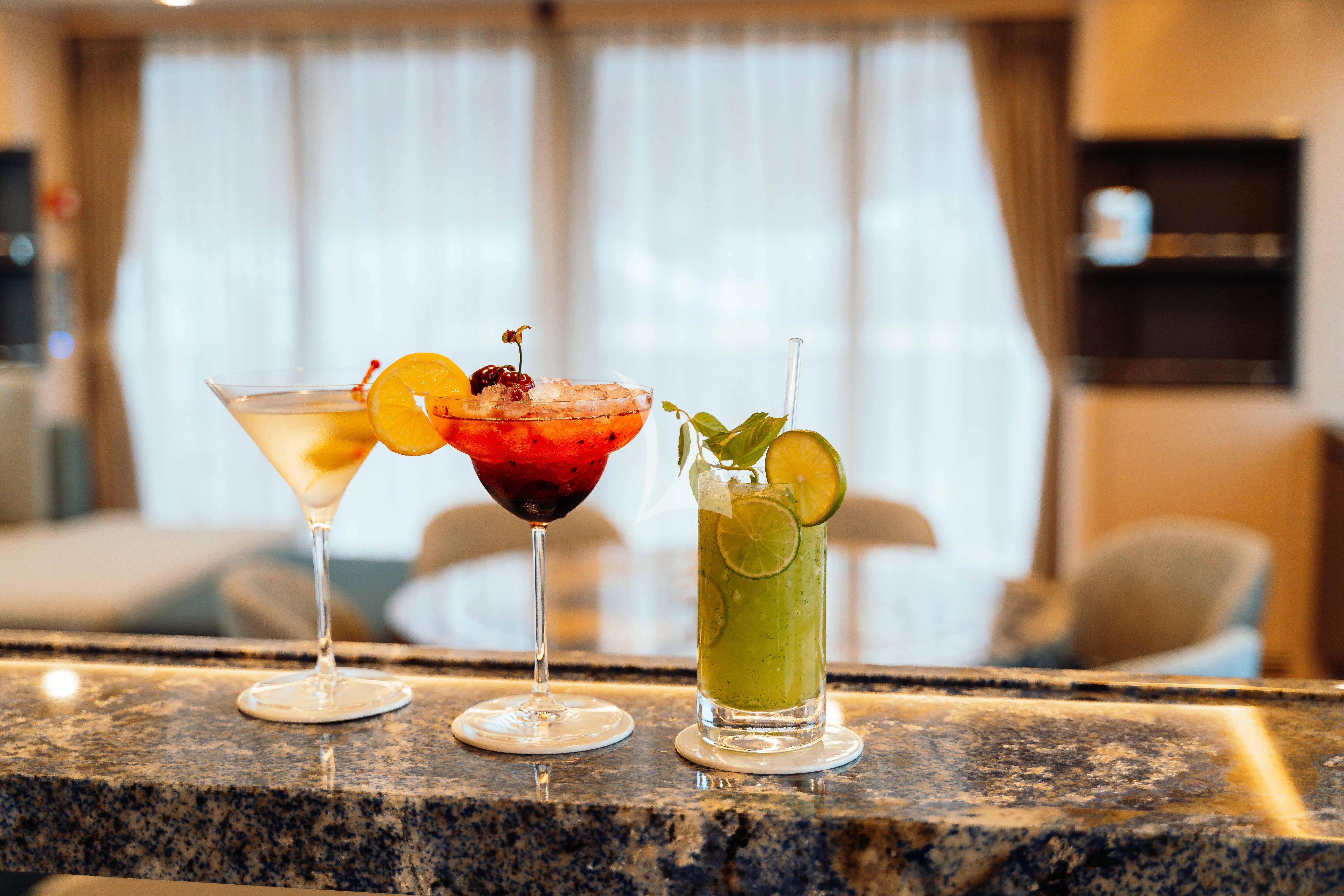 a group of glasses with different colored liquid in them aboard HEEUS Yacht for Sale