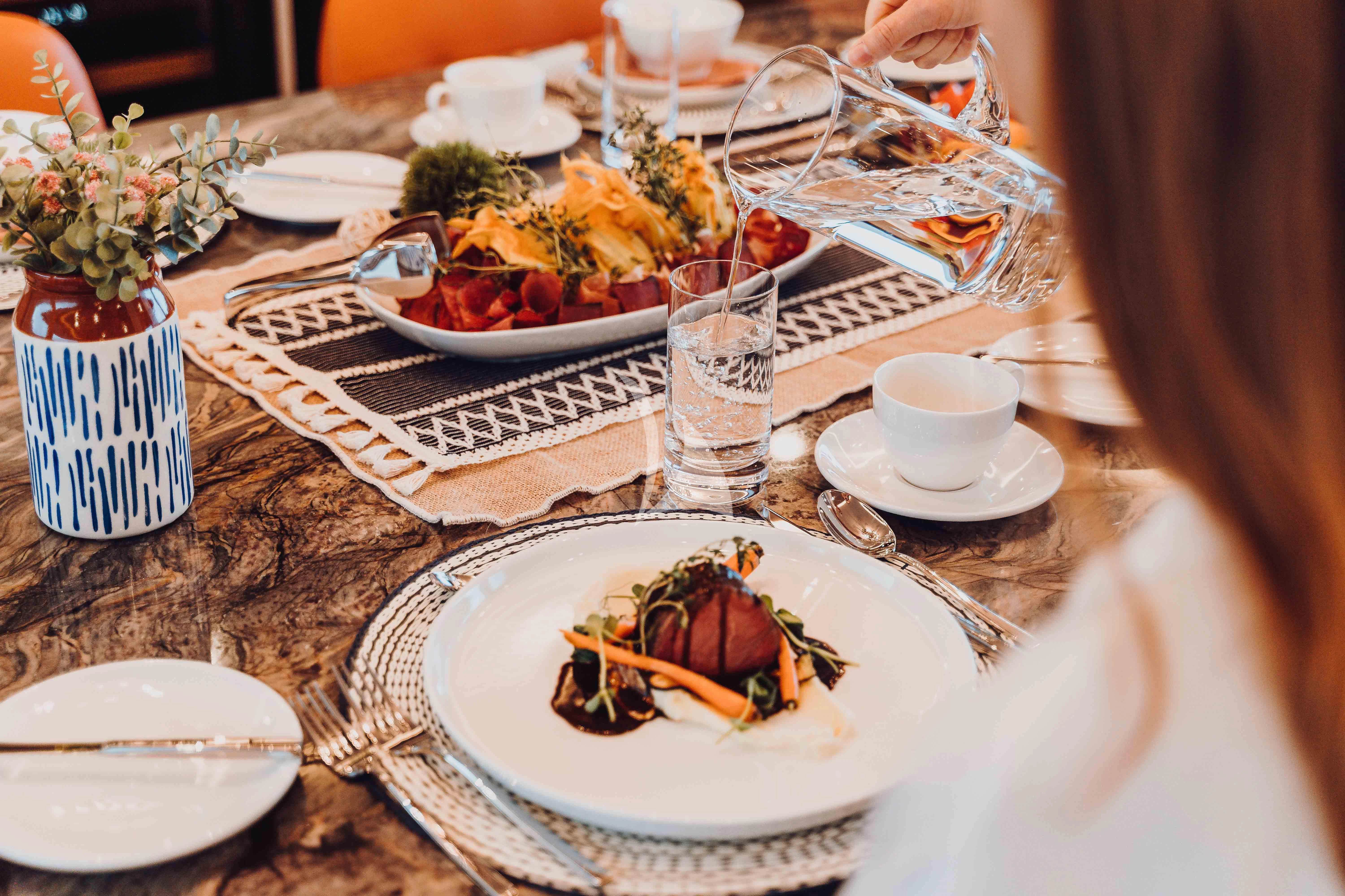 a table with plates of food and glasses on it aboard HEEUS Yacht for Sale