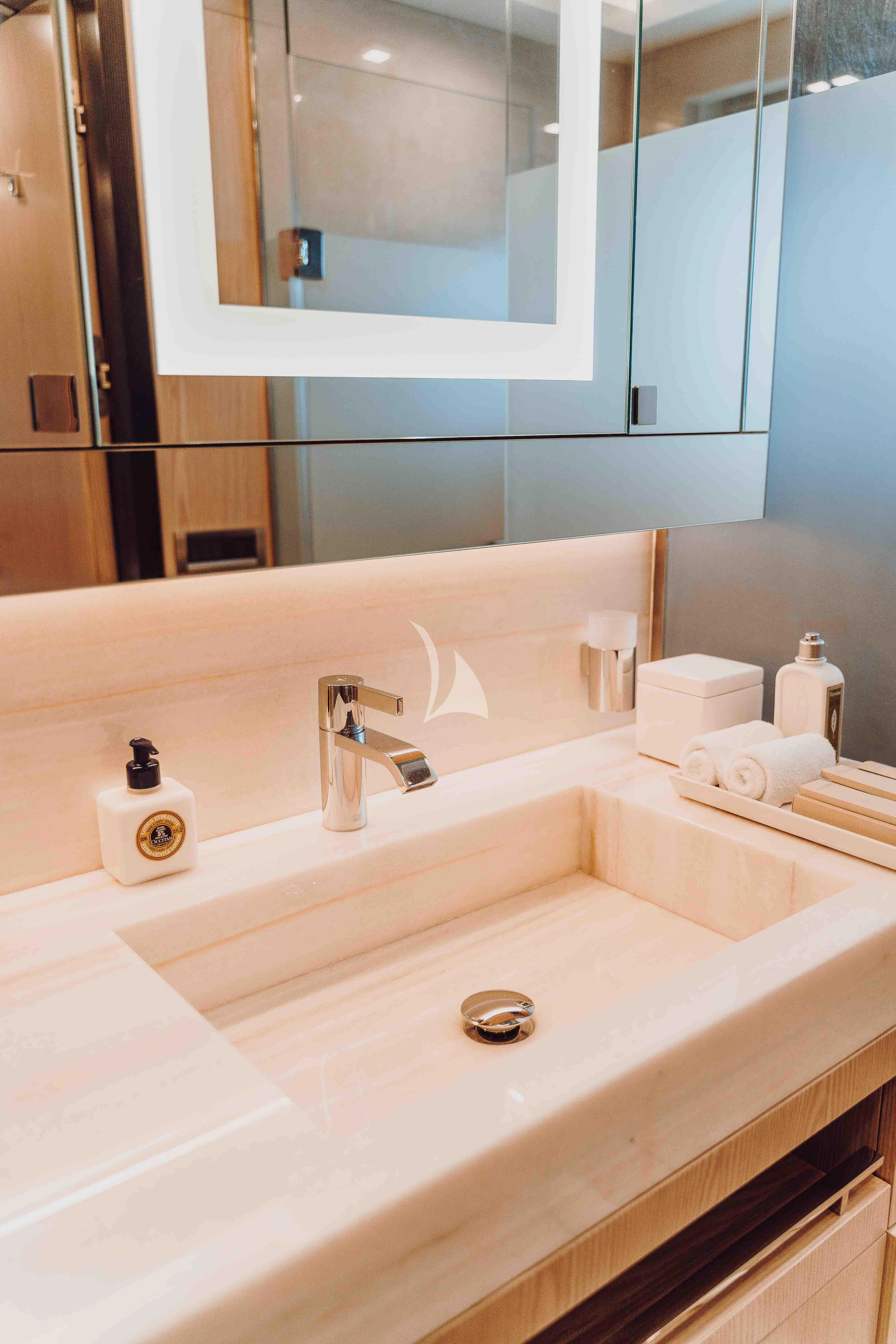 a bathroom with a large mirror aboard HEEUS Yacht for Sale