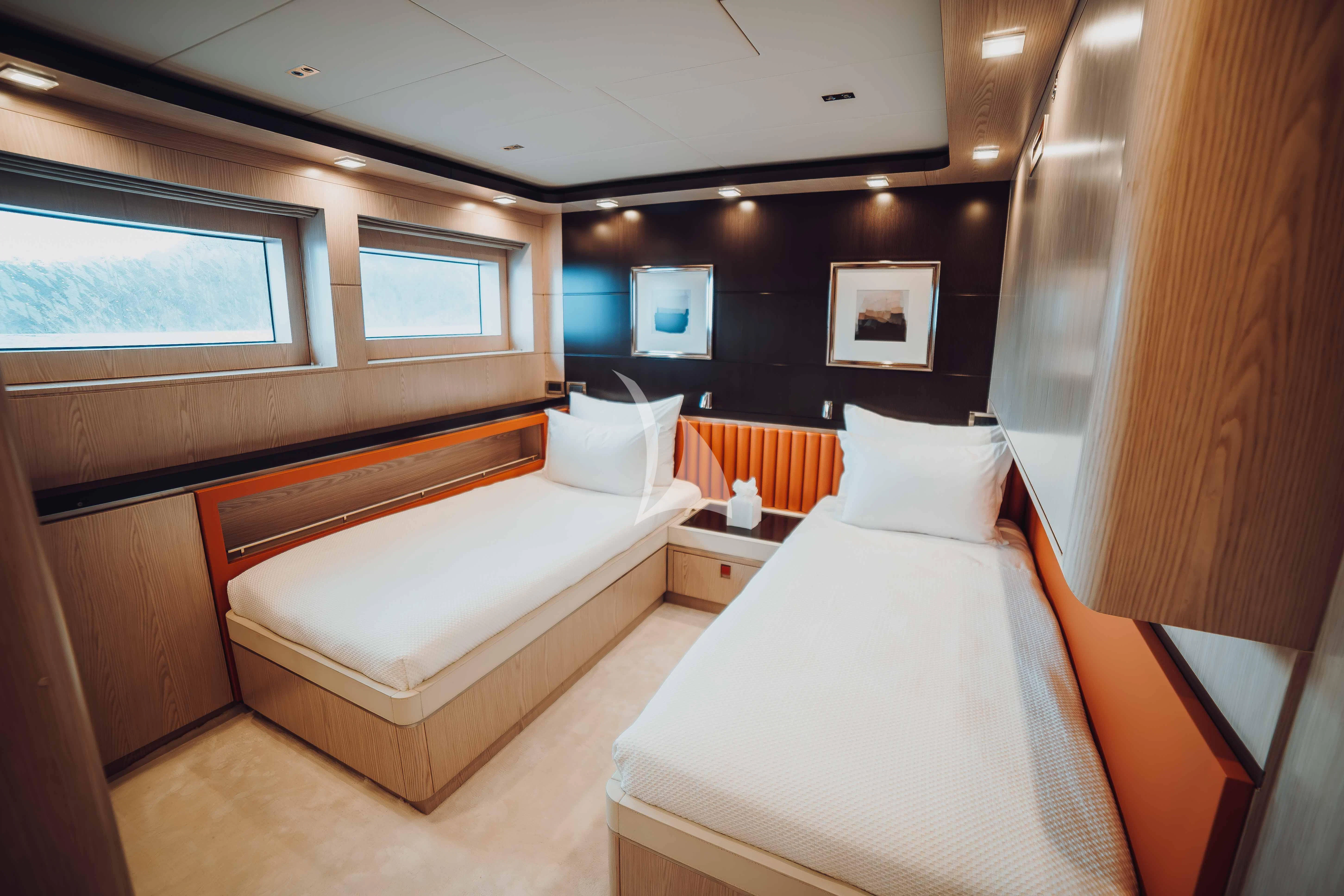 a room with beds and a tv aboard HEEUS Yacht for Sale