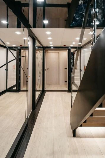 a hallway with metal railings aboard HEEUS Yacht for Sale
