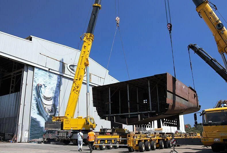a large crane with a large black object on top of it aboard HEEUS Yacht for Sale