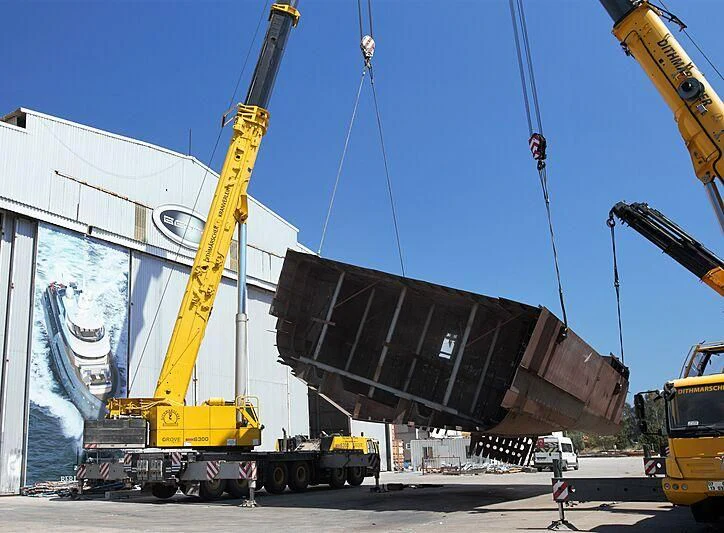 a crane lifting a building aboard HEEUS Yacht for Sale