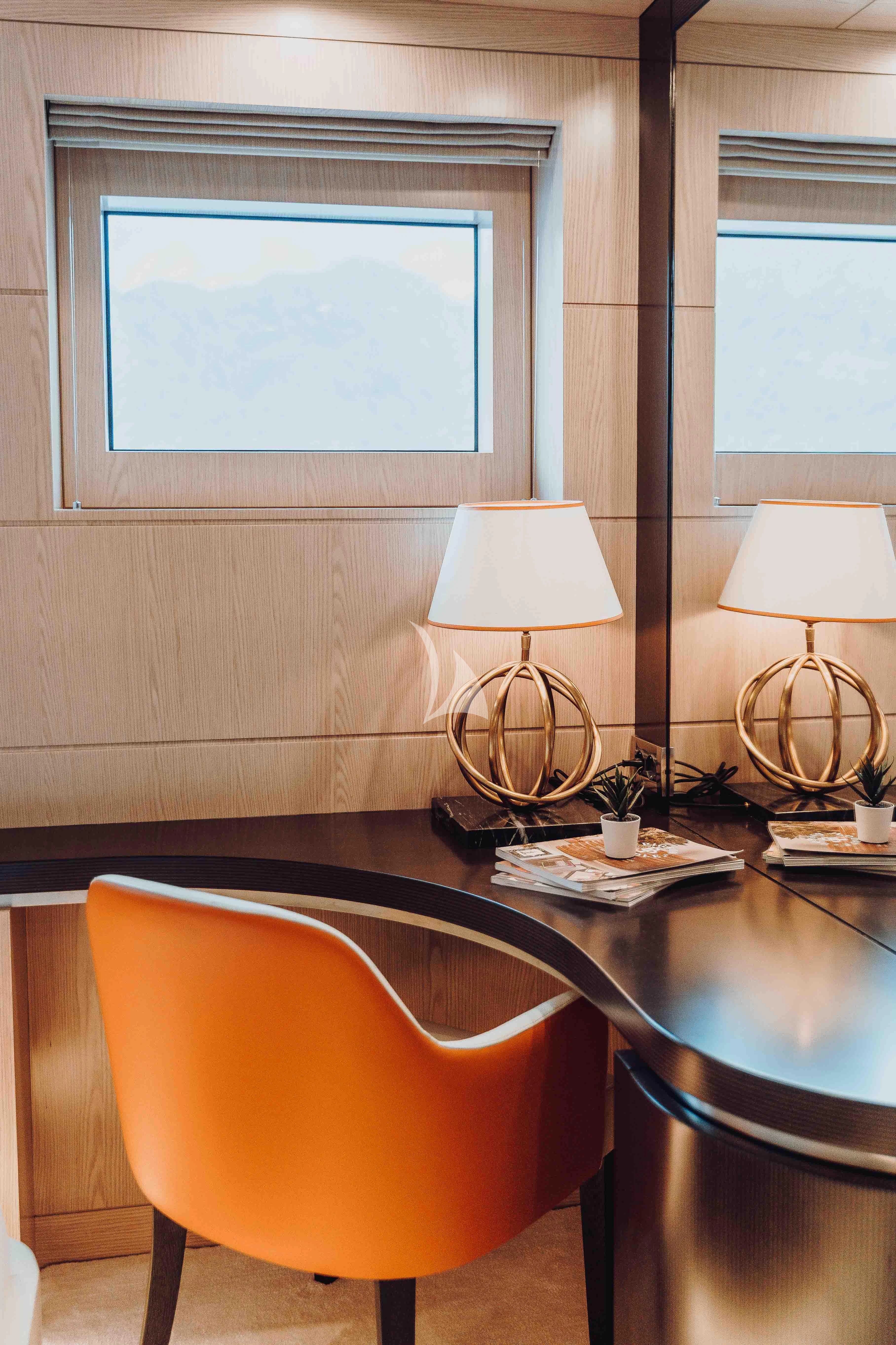 a desk with a lamp and a window aboard HEEUS Yacht for Sale