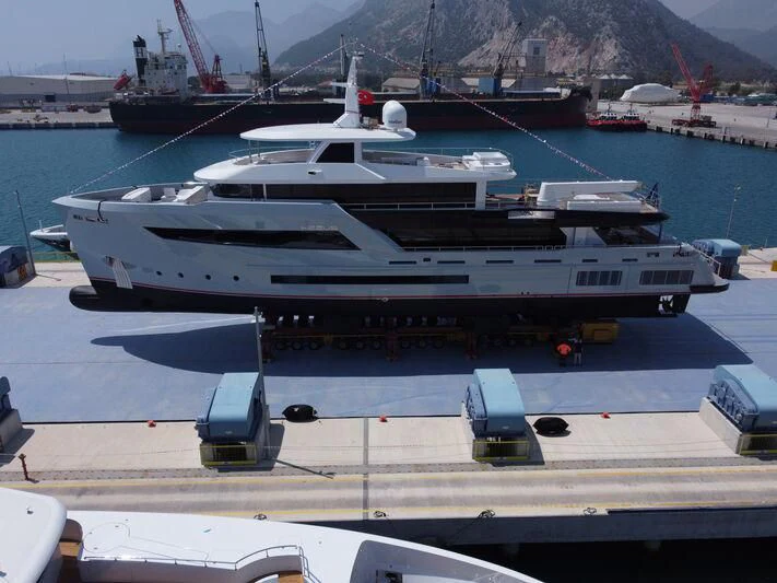 a large yacht docked at a port aboard HEEUS Yacht for Sale