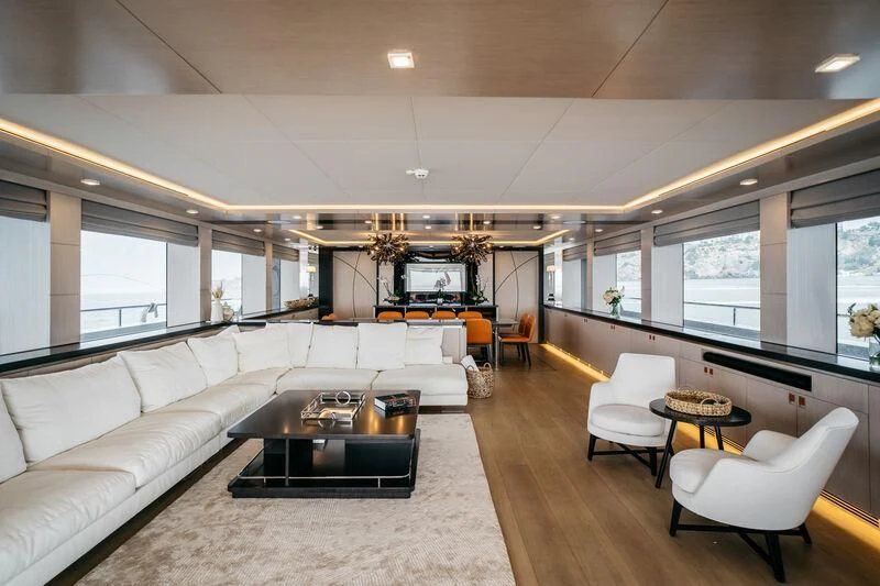 a living room with a couch and a coffee table aboard HEEUS Yacht for Sale