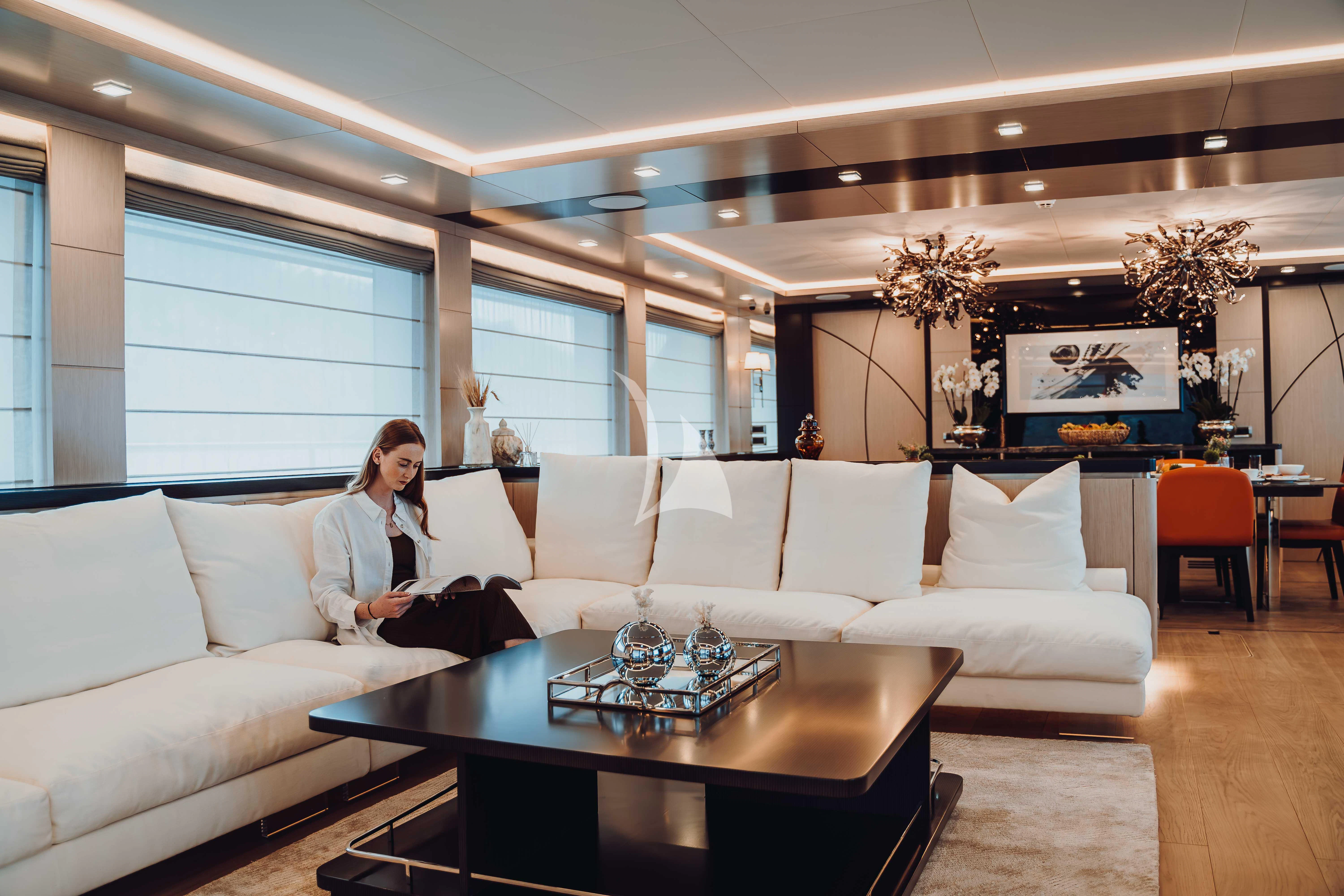 a person sitting on a couch aboard HEEUS Yacht for Sale