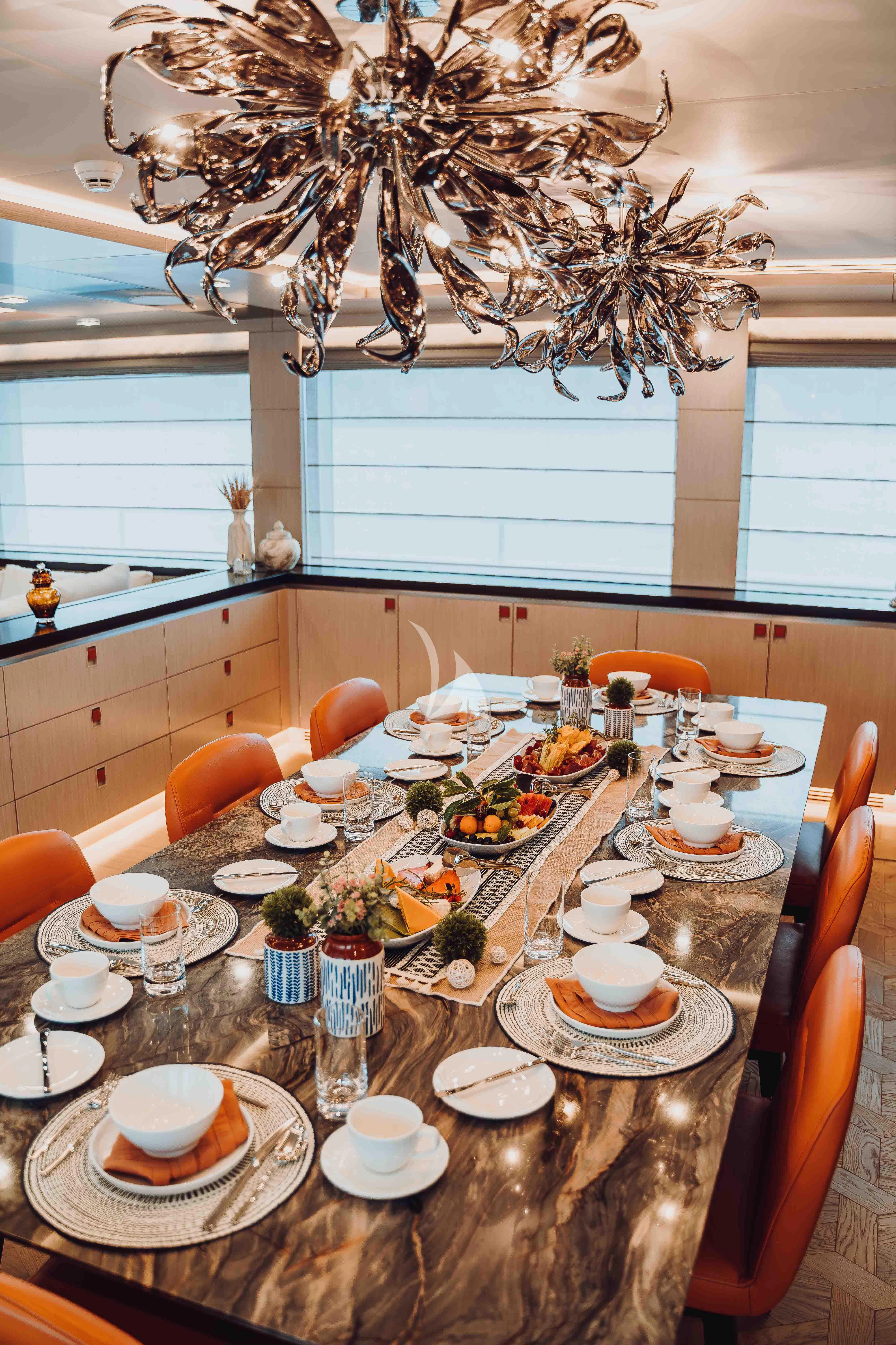 a table with plates and cups on it aboard HEEUS Yacht for Sale