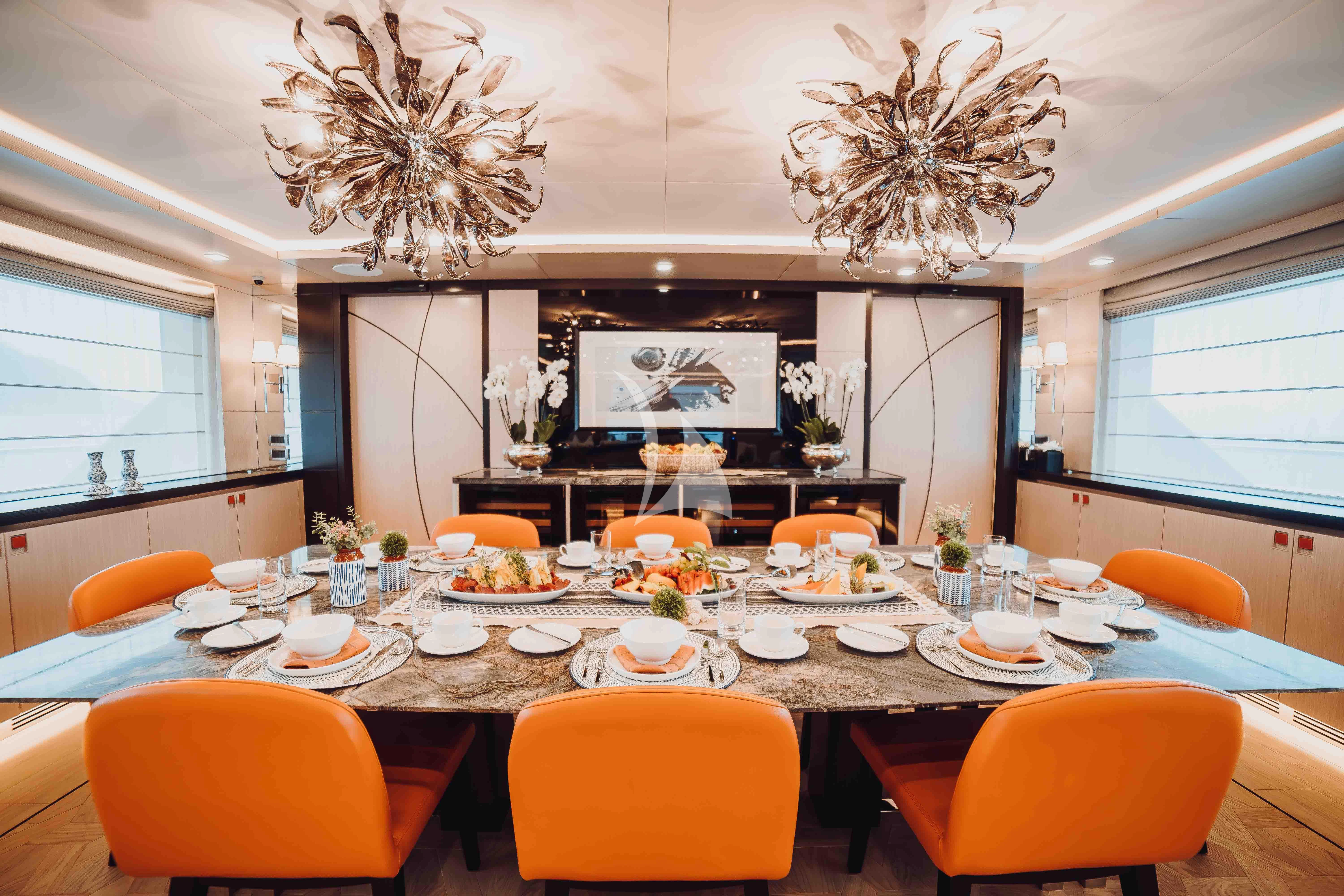 a large room with a chandelier and chairs aboard HEEUS Yacht for Sale