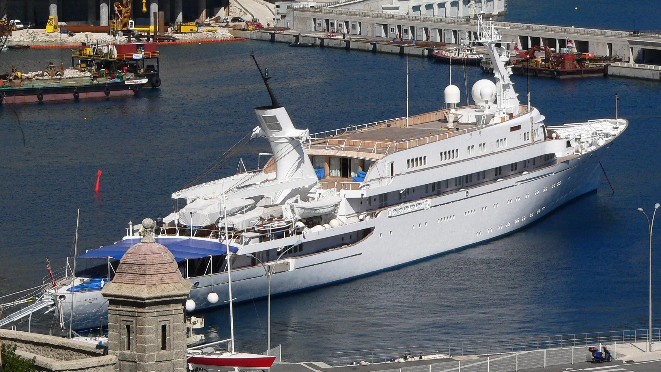 a large white boat in a harbor aboard ATLANTIS II Yacht for Sale