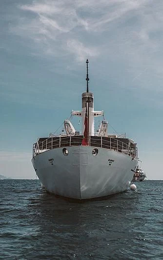 a large ship in the water aboard ATLANTIS II Yacht for Sale
