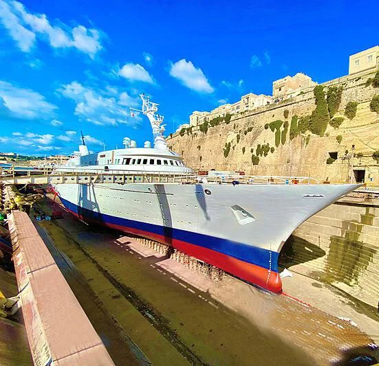 a large white boat on a river aboard ATLANTIS II Yacht for Sale