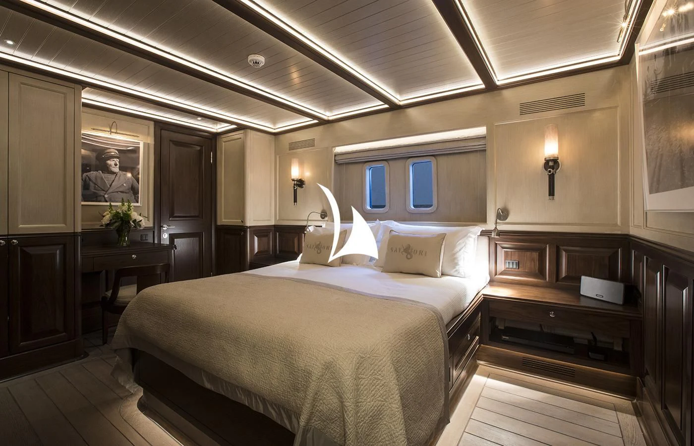 a hotel room with a bed and desk aboard SATORI Yacht for Charter